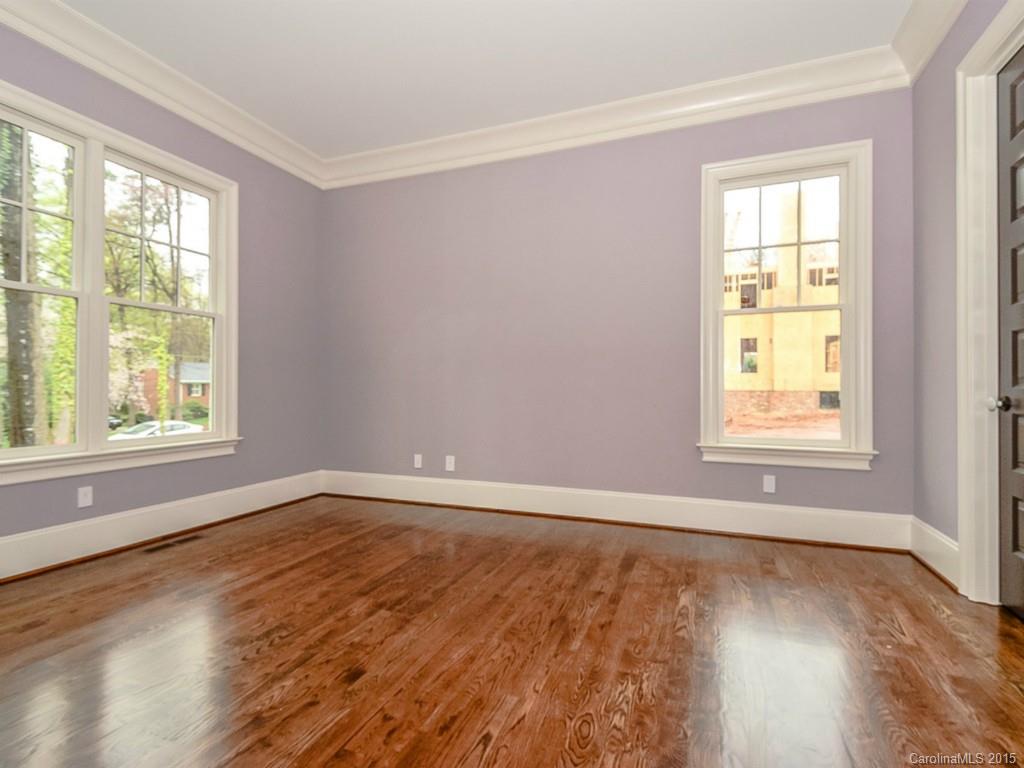 522 Ashworth Road Charlotte, NC 28211 - Photo 3 of 24 a view of an empty room with wooden floor and a window