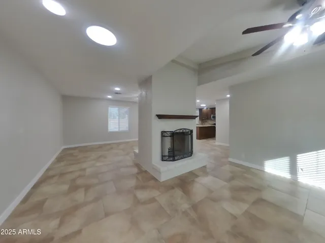 a view of empty room with a fireplace