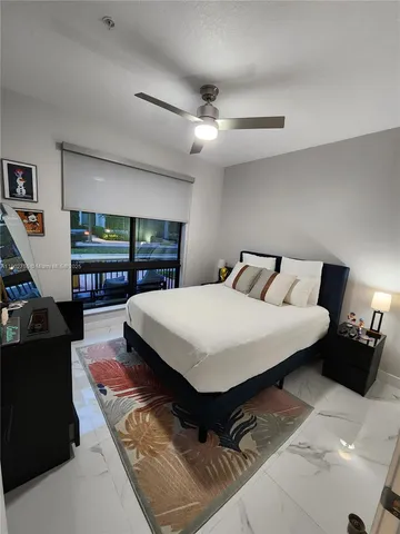 a bedroom with a large bed and a large window