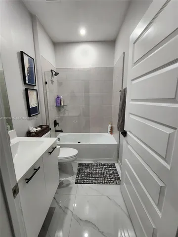 a bathroom with a sink a toilet and a bathtub