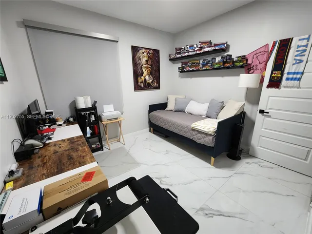 a bedroom with furniture and a wooden floor