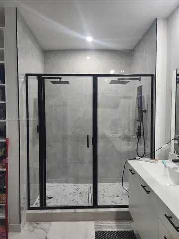 a bathroom with a shower and a sink
