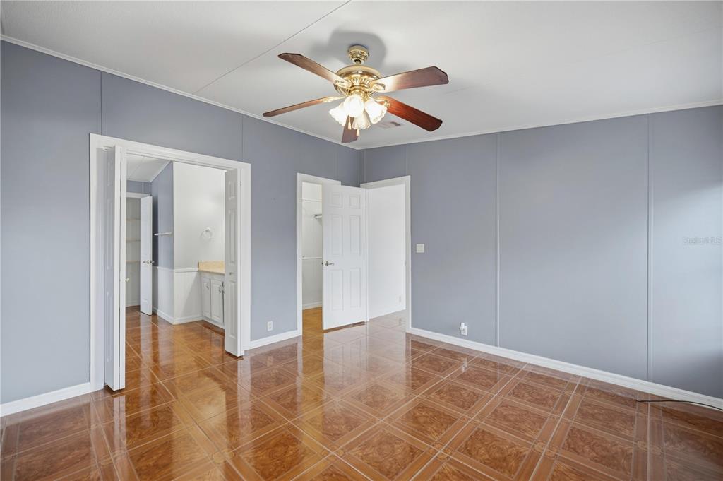 6524 Southeast 110th Lane Belleview, FL 34420 - Photo 12 of 32 a view of an empty room with window and a chandelier fan
