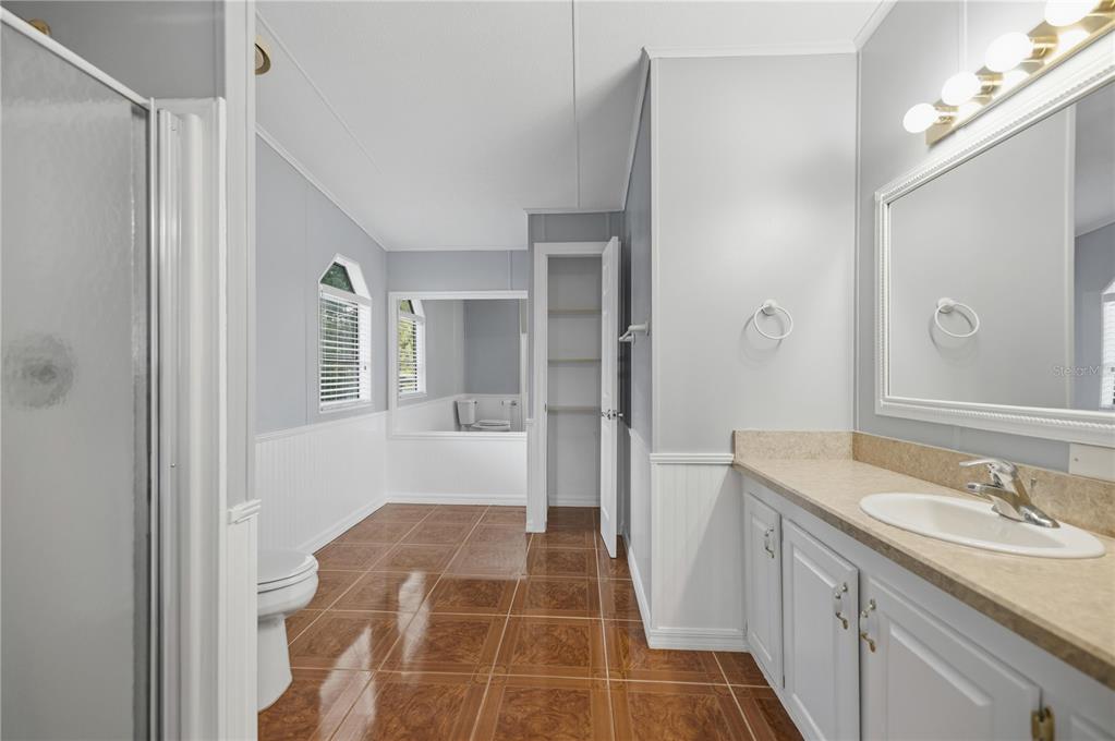 6524 Southeast 110th Lane Belleview, FL 34420 - Photo 13 of 32 a bathroom with a sink and a mirror