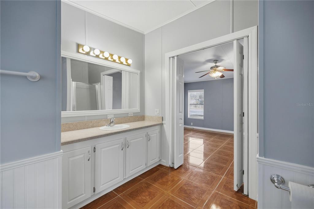 6524 Southeast 110th Lane Belleview, FL 34420 - Photo 14 of 32 a spacious bathroom with a mirror and a sink