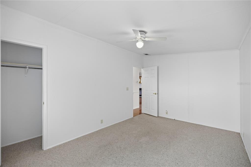 6524 Southeast 110th Lane Belleview, FL 34420 - Photo 17 of 32 an empty room with a ceiling fan and a window