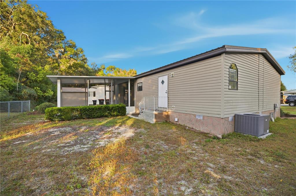 6524 Southeast 110th Lane Belleview, FL 34420 - Photo 24 of 32 a view of a house with backyard and garden