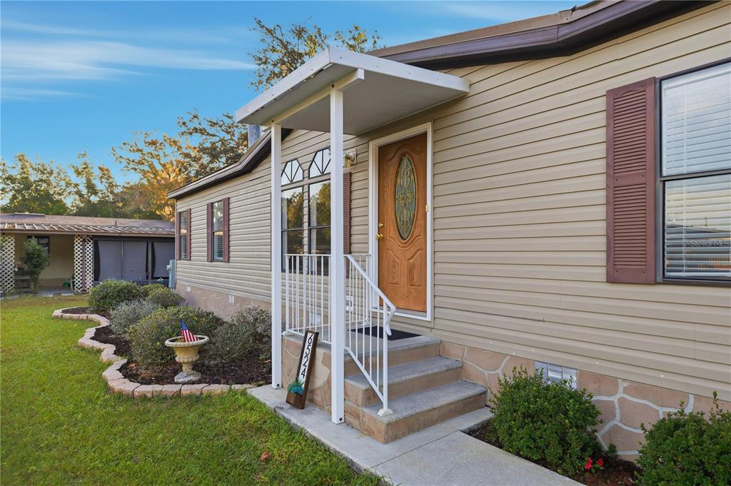 6524 Southeast 110th Lane Belleview, FL 34420 - Photo 3 of 32 a front view of a house with a yard