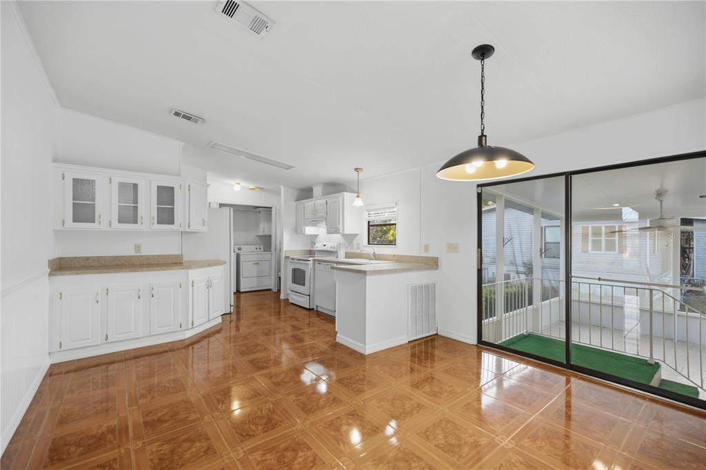 6524 Southeast 110th Lane Belleview, FL 34420 - Photo 7 of 32 a kitchen with white cabinets and white appliances
