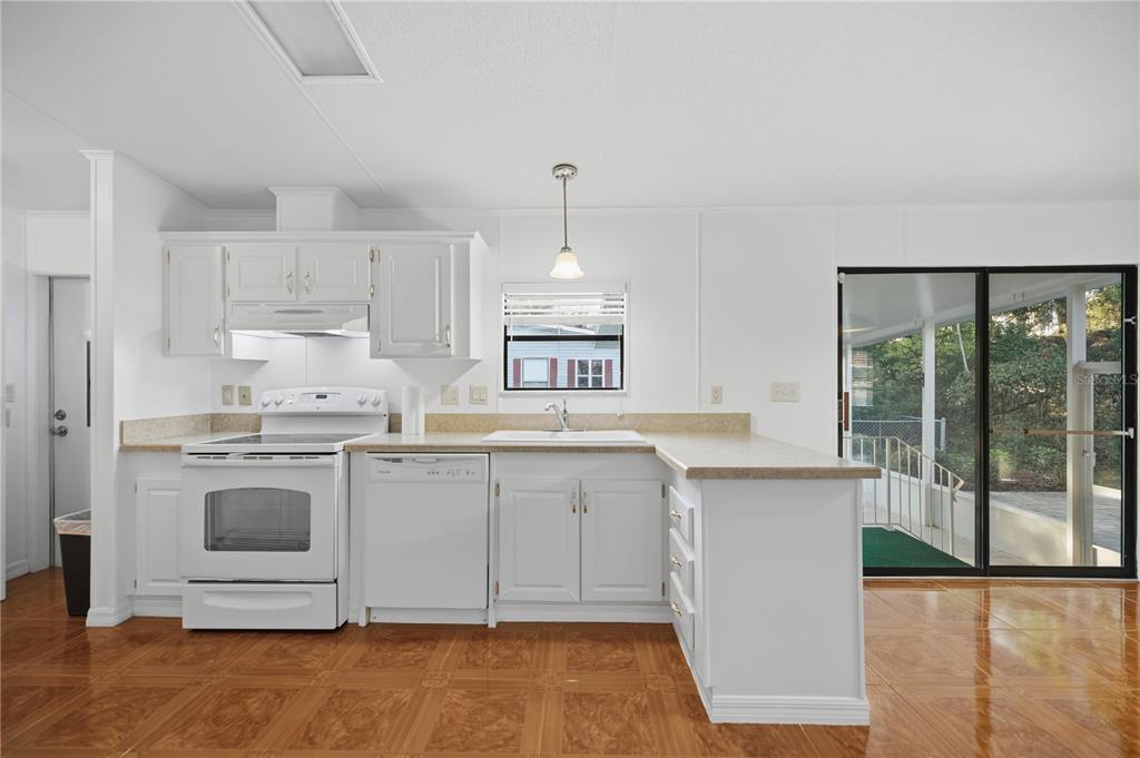 6524 Southeast 110th Lane Belleview, FL 34420 - Photo 8 of 32 a kitchen with granite countertop a sink stainless steel appliances and cabinets