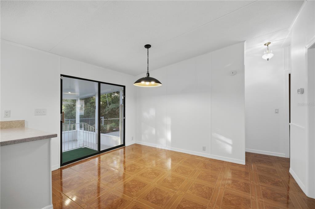 6524 Southeast 110th Lane Belleview, FL 34420 - Photo 9 of 32 a view of an empty room with a sliding door