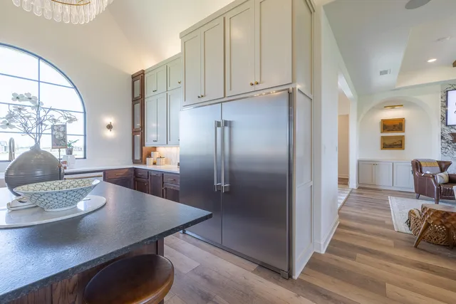 a kitchen with stainless steel appliances a stove a sink and a refrigerator