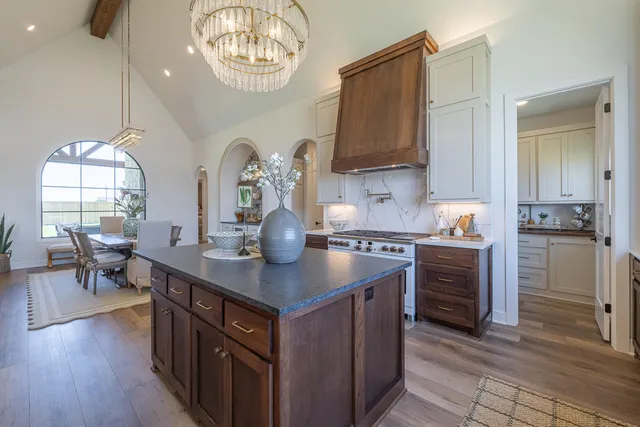 a kitchen with granite countertop white cabinets and sink