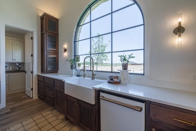 a kitchen with stainless steel appliances a sink stove and cabinets