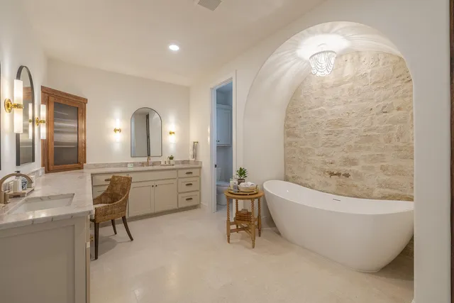 a bathroom with a tub shower and a sink