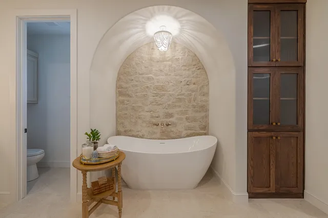 a bedroom with a bed and a lamp on table