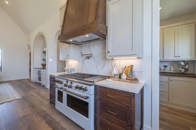a living room with furniture large window and a fireplace