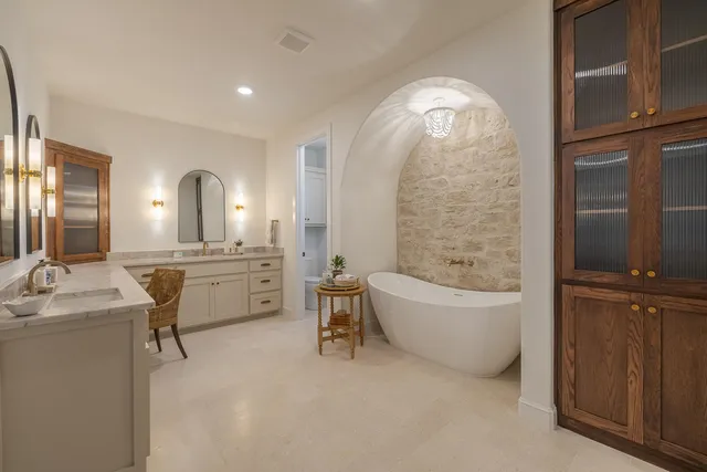 a living room with furniture a fireplace and potted plants