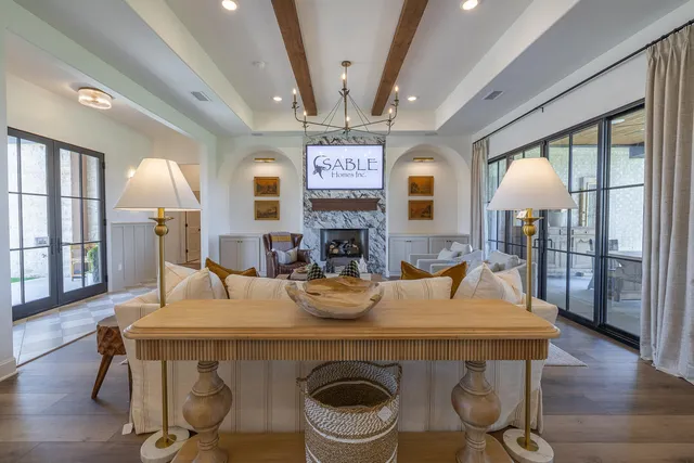 a kitchen with stainless steel appliances granite countertop a refrigerator a stove a sink dishwasher a dining table and chairs with wooden floor