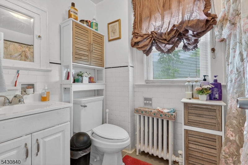 1629 May Street Union, NJ 07083 - Photo 5 of 13 a bathroom with a sink toilet and a mirror