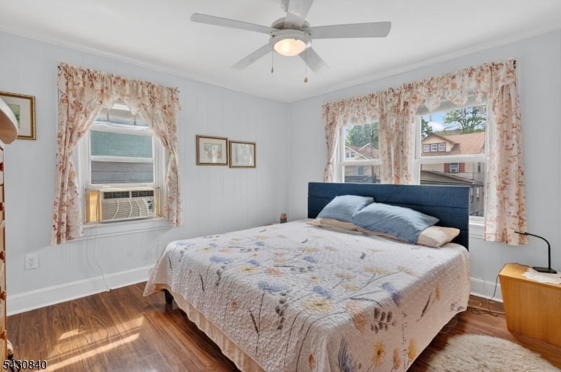 1629 May Street Union, NJ 07083 - Photo 7 of 13 a bedroom with a large bed and a chandelier fan