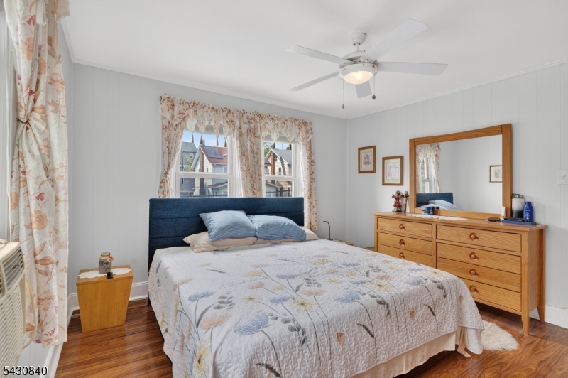 1629 May Street Union, NJ 07083 - Photo 8 of 13 a bedroom with a large bed and a chandelier