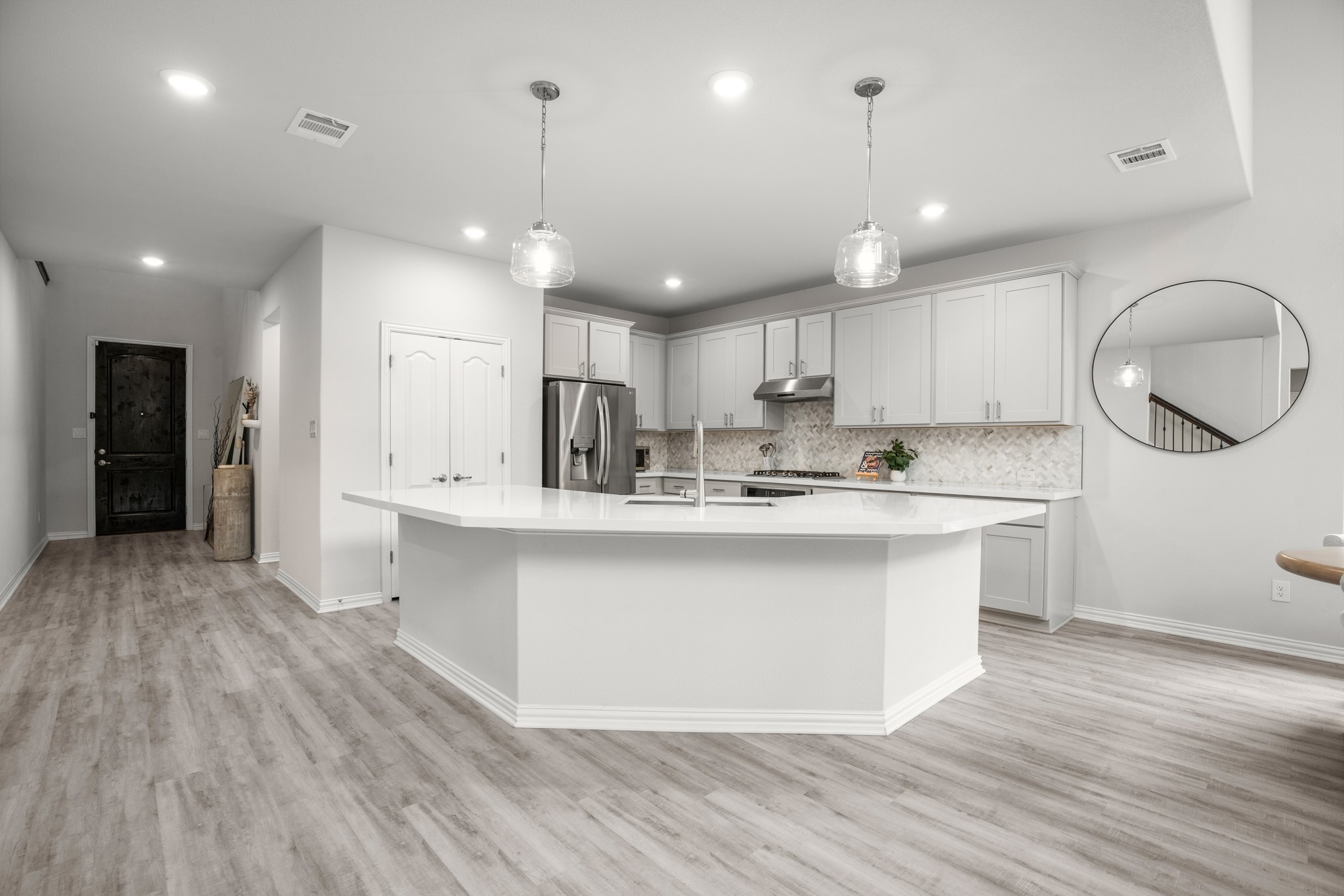 6708 Avila Way Pflugerville, TX 78660 - Photo 11 of 36 a kitchen with kitchen island a sink and a stove top oven