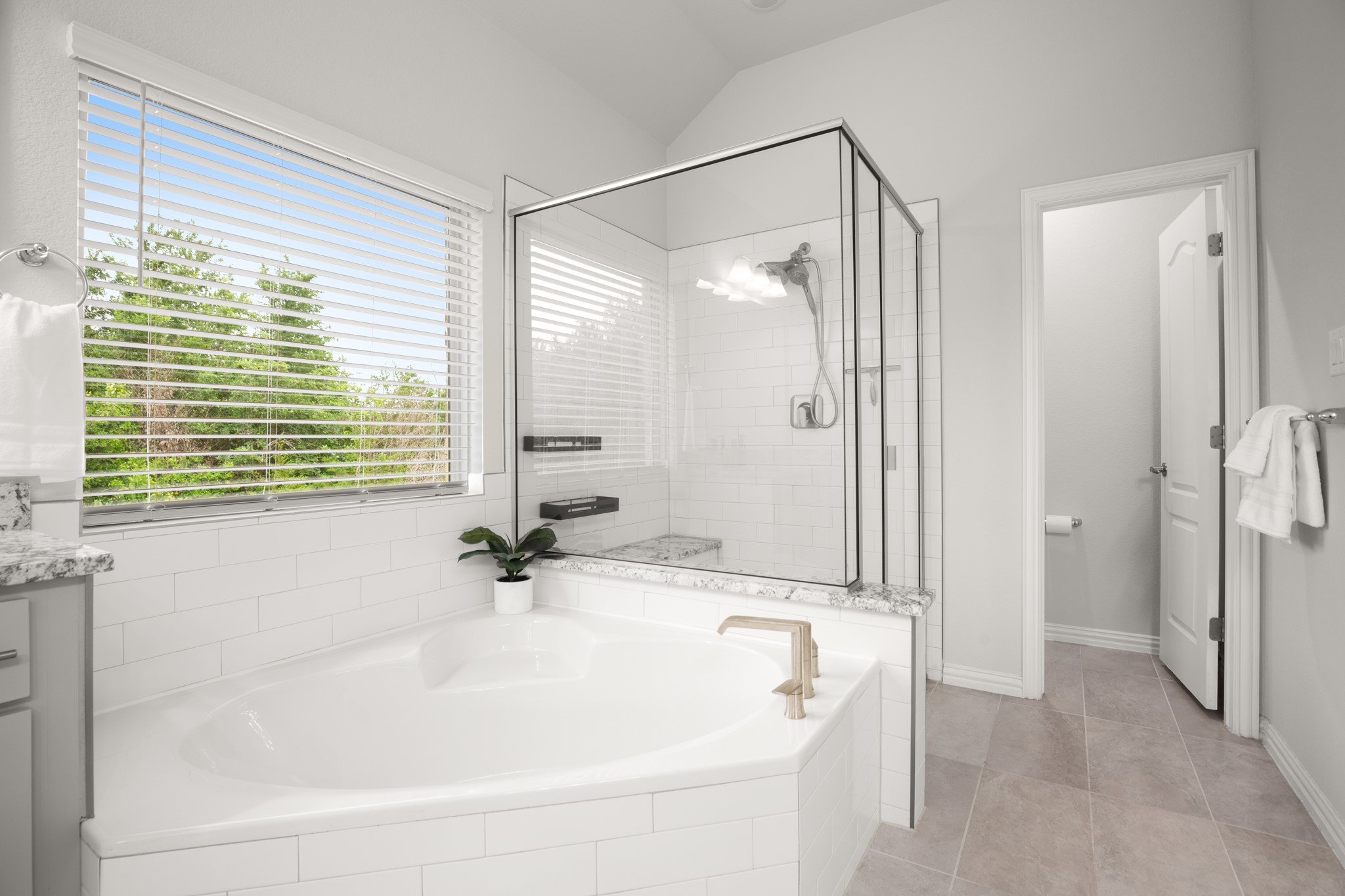 6708 Avila Way Pflugerville, TX 78660 - Photo 18 of 36 a bathroom with a granite countertop sink a shower and a mirror