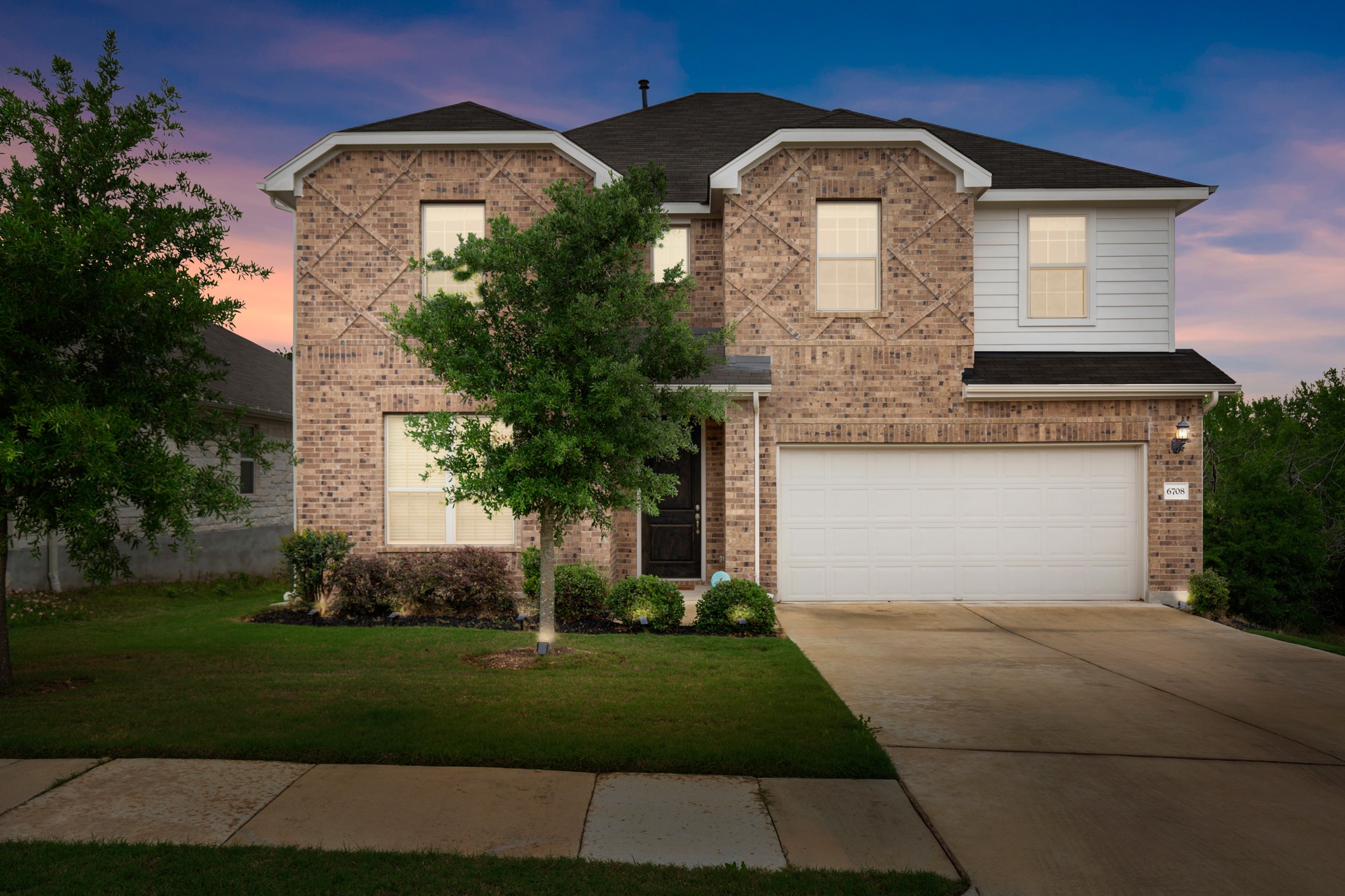 6708 Avila Way Pflugerville, TX 78660 - Photo 5 of 36 a front view of a house with a garden