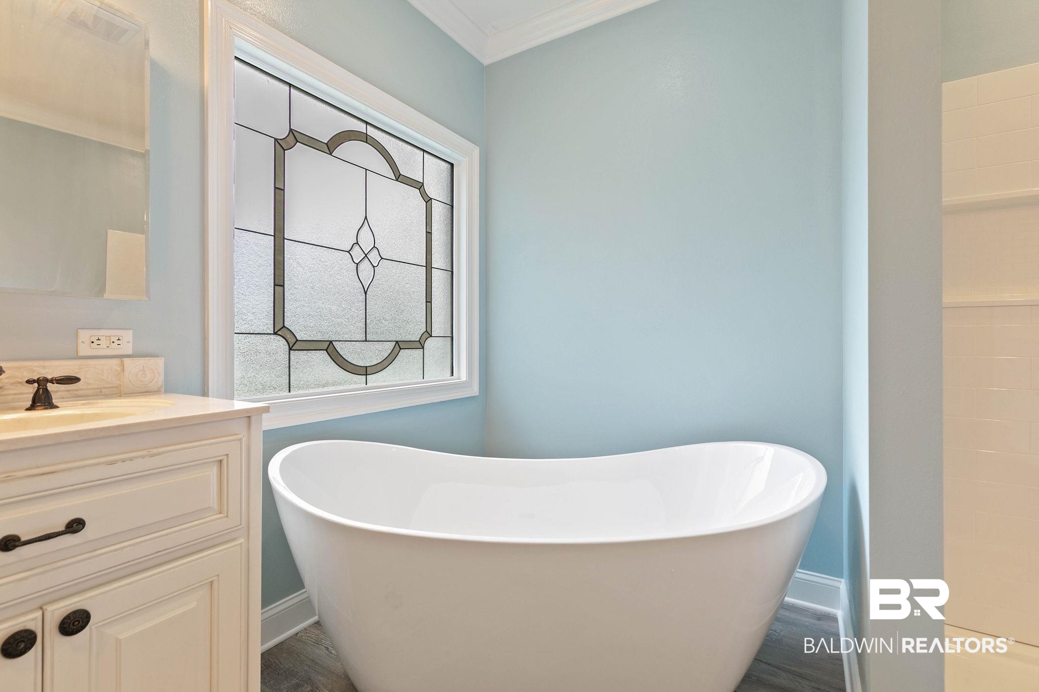 3668 Claridge Road North Mobile, AL 36608 - Photo 54 of 100 Full bath with a freestanding tub, vanity, ornamental molding, and dark wood finished floors
