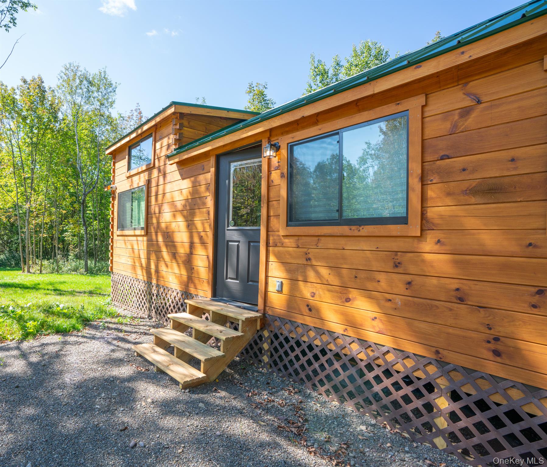 2155 Ed Klug Road Franklin, NY 13839 - Photo 4 of 24 a blue bench sitting in front of a house