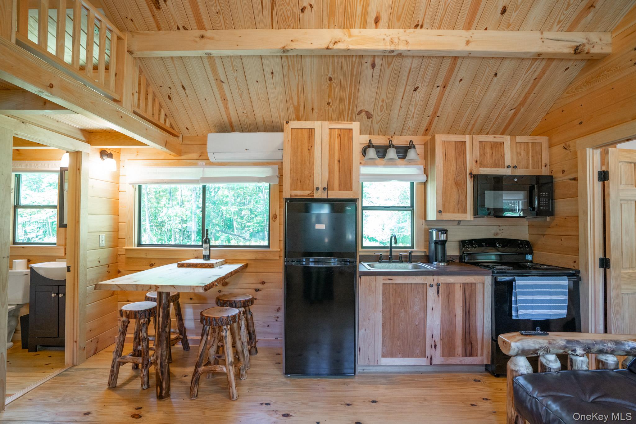2155 Ed Klug Road Franklin, NY 13839 - Photo 6 of 24 a kitchen with stainless steel appliances kitchen island granite countertop a refrigerator and a stove top oven