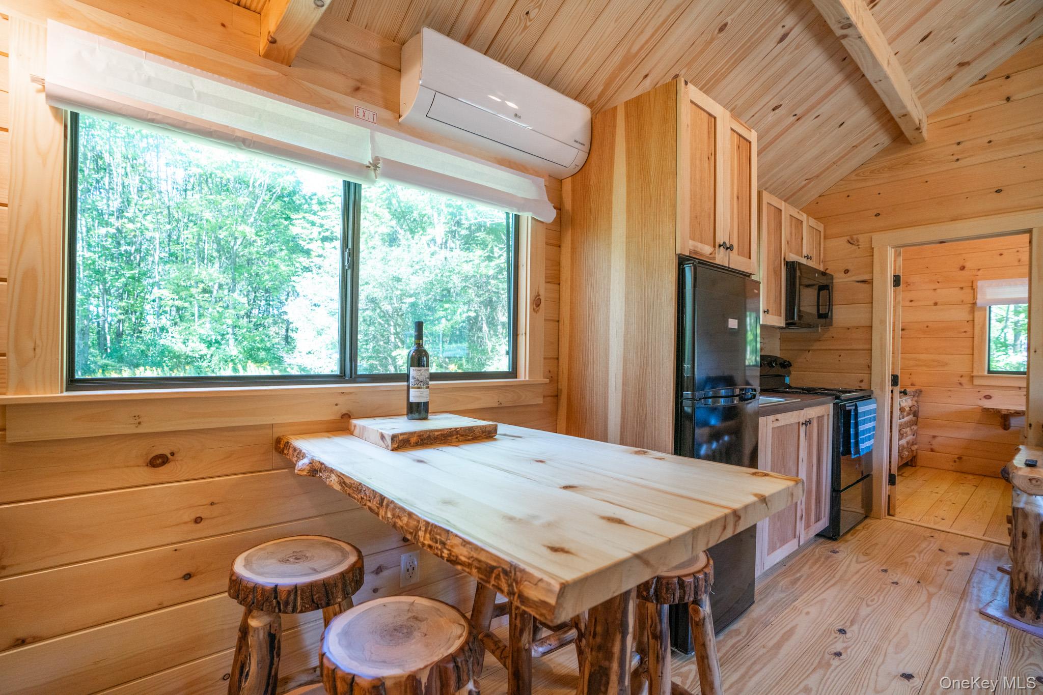 2155 Ed Klug Road Franklin, NY 13839 - Photo 10 of 24 a kitchen with a stove a refrigerator and a dining table