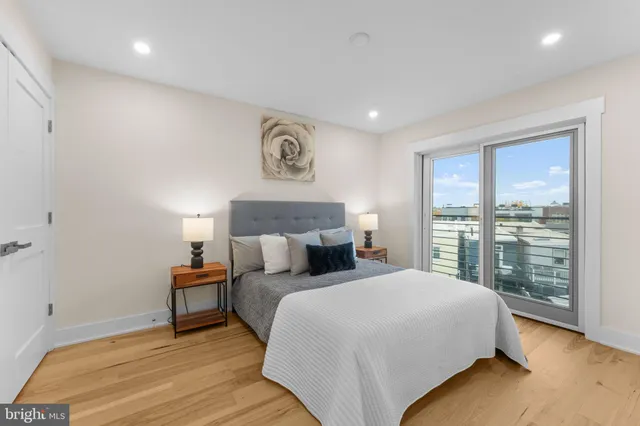 a bedroom with a bed and a large window