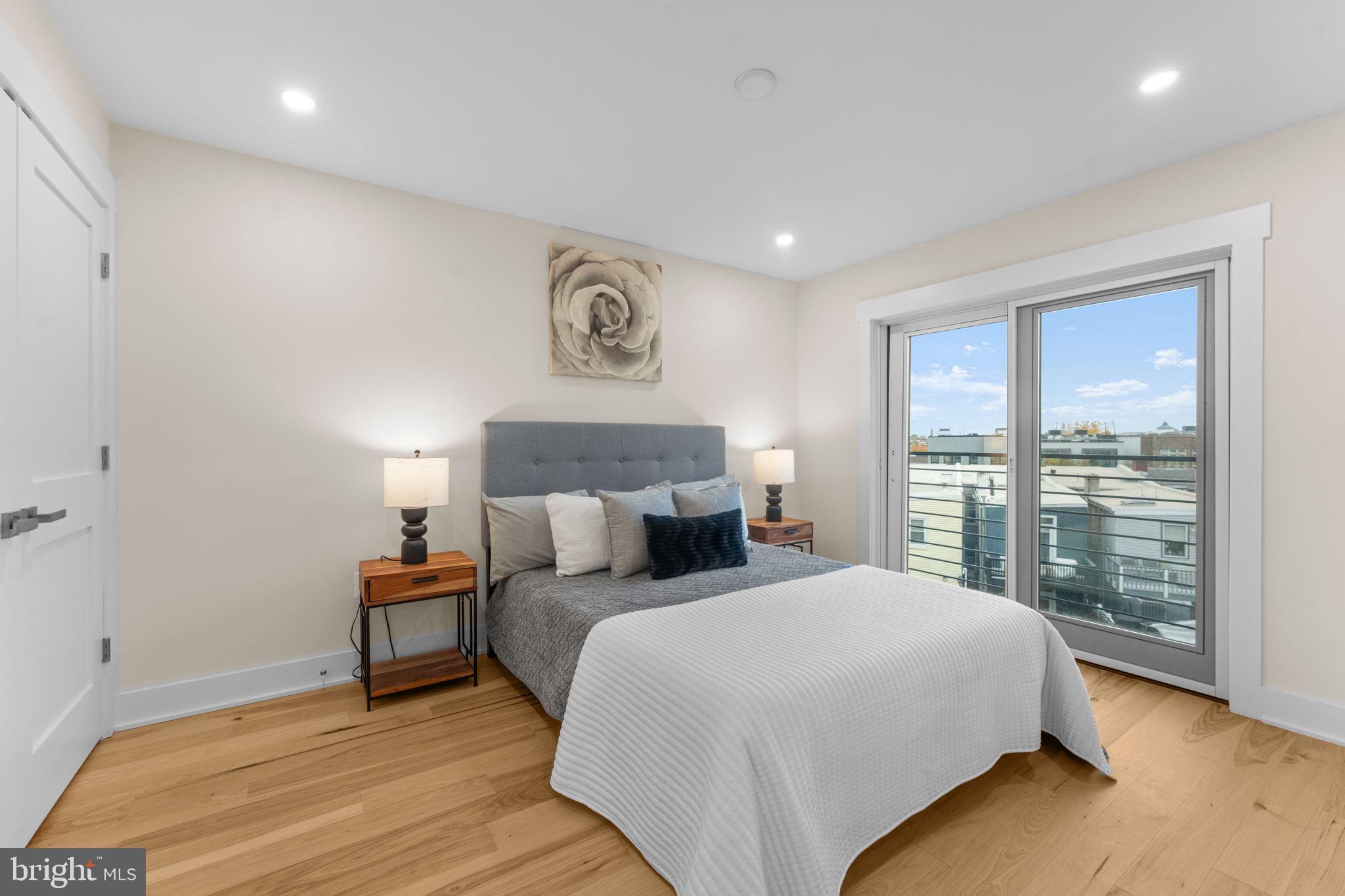 521 Florida Avenue Northeast, Unit 2 Washington, DC 20002 - Photo 17 of 38 a bedroom with a bed and a large window