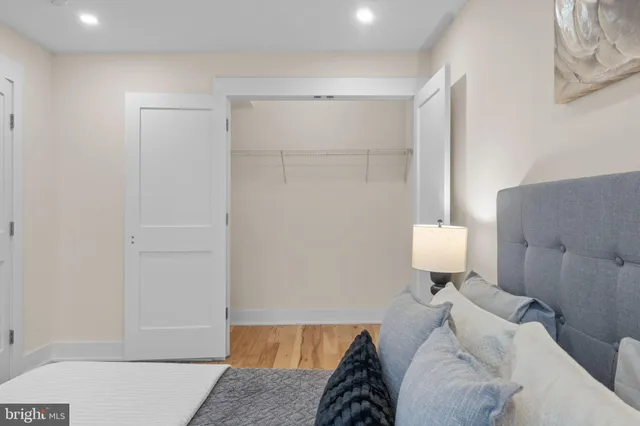 a bedroom with a bed and mirror