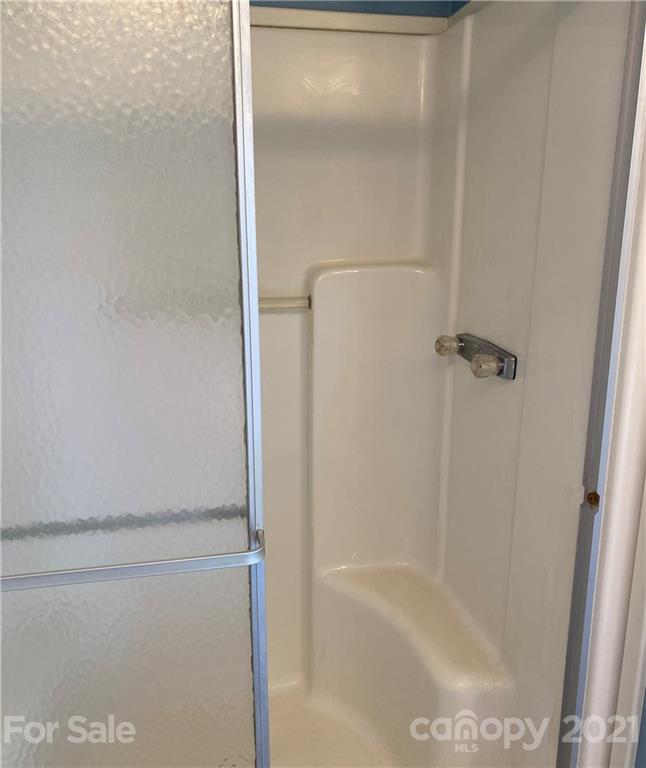525 Goodwin Road Salisbury, NC 28146 - Photo 20 of 46 a bathroom with a glass shower door