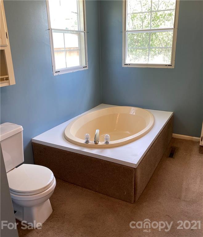 525 Goodwin Road Salisbury, NC 28146 - Photo 21 of 46 a white bath tub sitting next to a white toilet