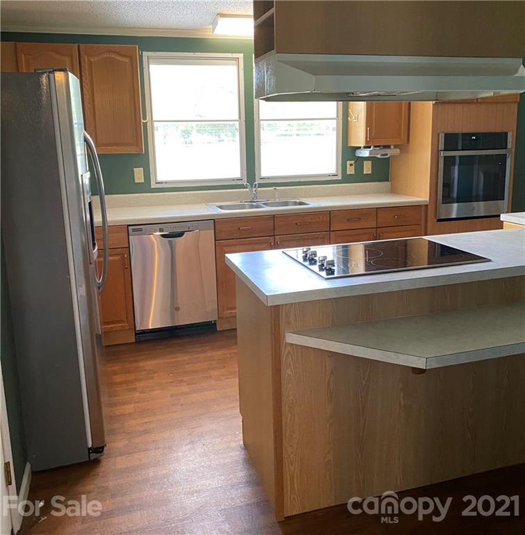 525 Goodwin Road Salisbury, NC 28146 - Photo 4 of 46 a kitchen with a sink a window and a refrigerator