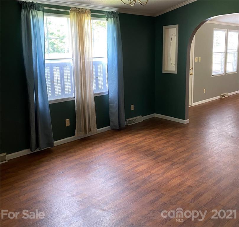 525 Goodwin Road Salisbury, NC 28146 - Photo 8 of 46 an empty room with wooden floor and windows