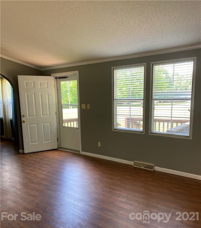 525 Goodwin Road Salisbury, NC 28146 - Photo 9 of 46 a view of an empty room with wooden floor and a window
