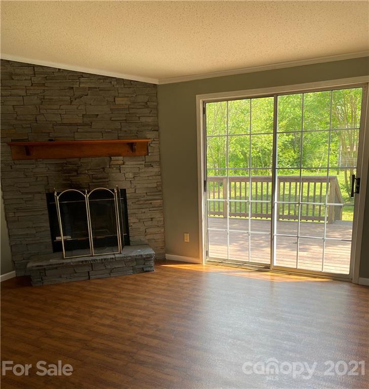 525 Goodwin Road Salisbury, NC 28146 - Photo 10 of 46 a view of empty room with wooden floor and fireplace