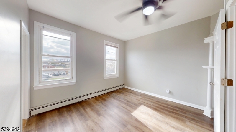 277 2nd Avenue West Newark, NJ 07107 - Photo 1 of 7 a view of an empty room with wooden floor and a window