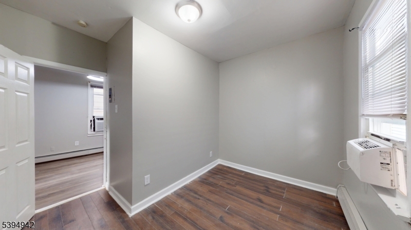 277 2nd Avenue West Newark, NJ 07107 - Photo 7 of 7 an empty room with wooden floor and windows