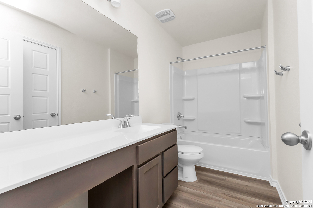 9402 Griffith Run Converse, TX 78109 - Photo 8 of 18 a bathroom with a sink a toilet and shower