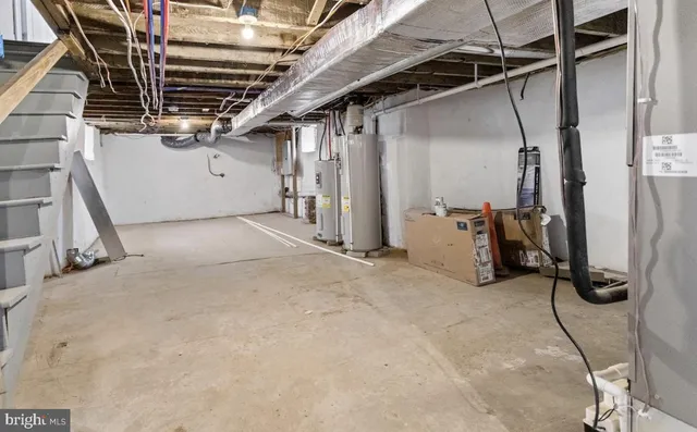 a view of an empty room with wooden stairs