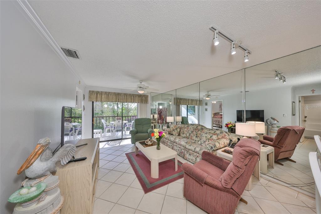6123 113th Street, Unit 510 Seminole, FL 33772 - Photo 13 of 44 a living room with furniture and a large window
