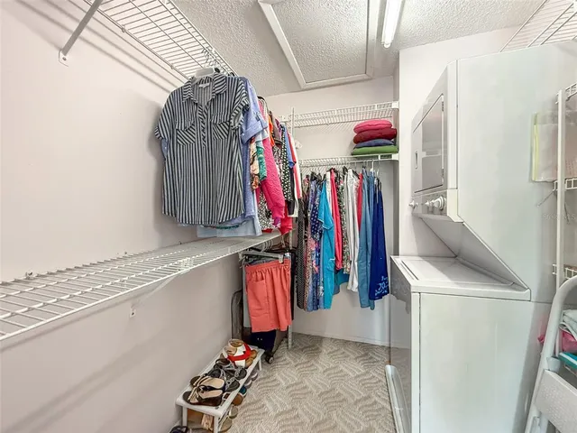 a view of walk in closet with clothes
