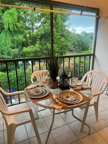 a view of a patio with furniture and wooden floor