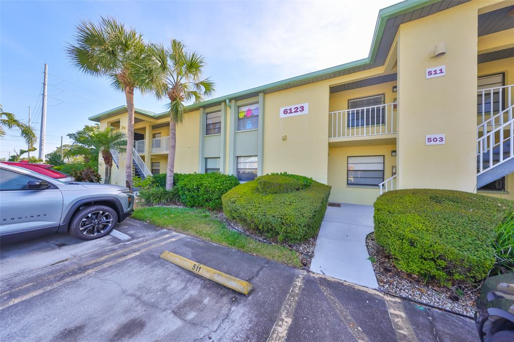 6123 113th Street, Unit 510 Seminole, FL 33772 - Photo 21 of 44 a front view of a house with garden